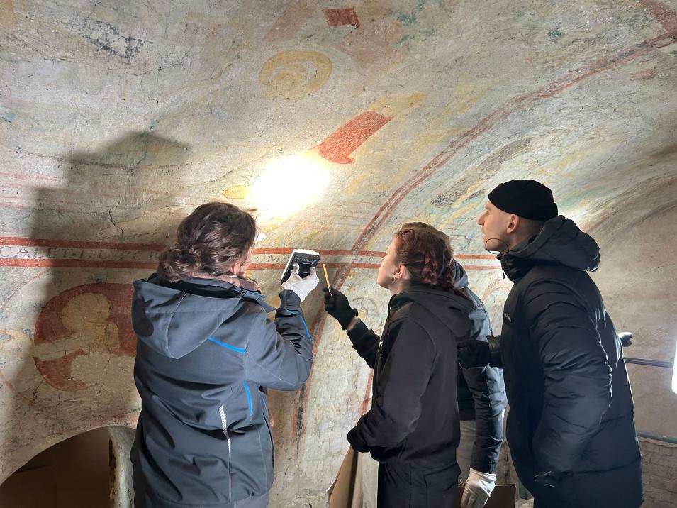 Studierende bei der Untersuchung der Herstellungstechnik von Malschicht und Putz